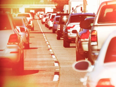Many cars in a traffic jam in the summer heat