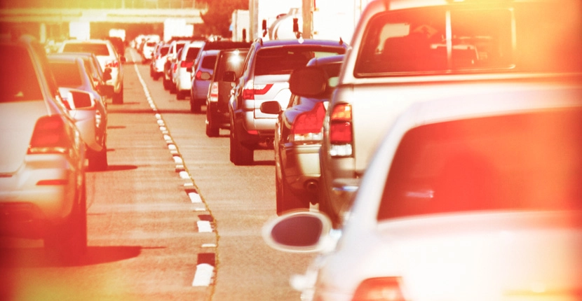 Many cars in a traffic jam in the summer heat