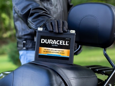 Motorcycle rider with a battery on the seat