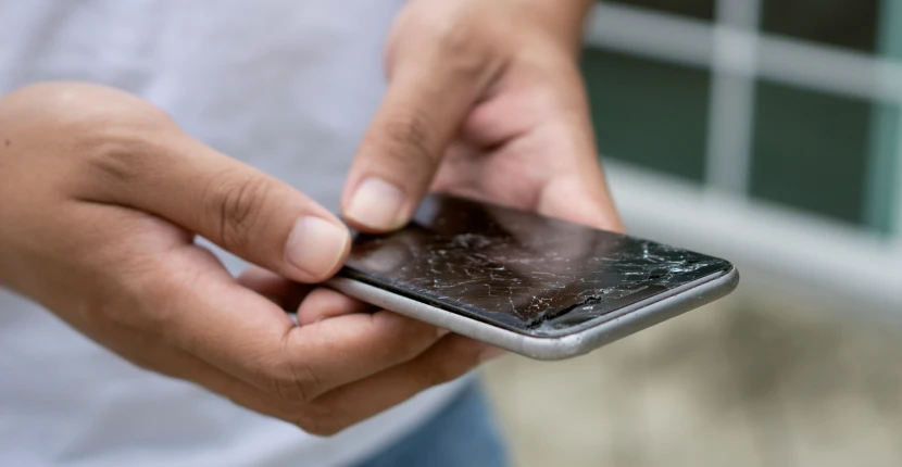 Holding a broken iPhone