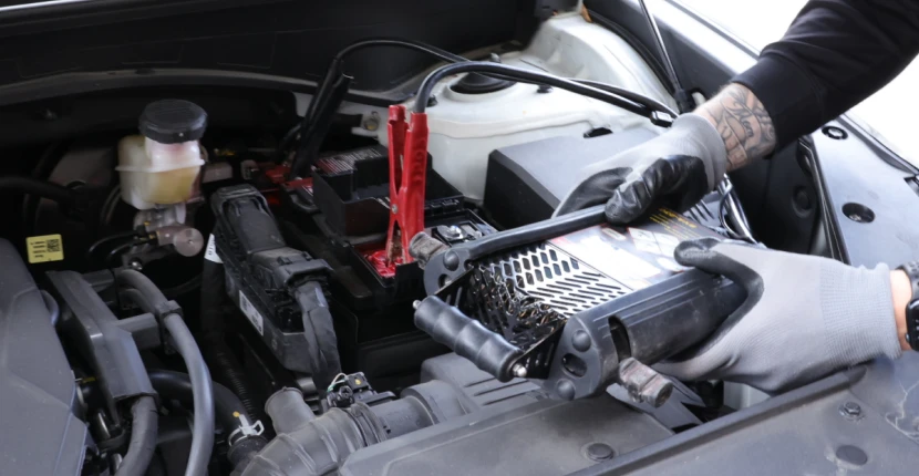 Using a battery tester on a car battery