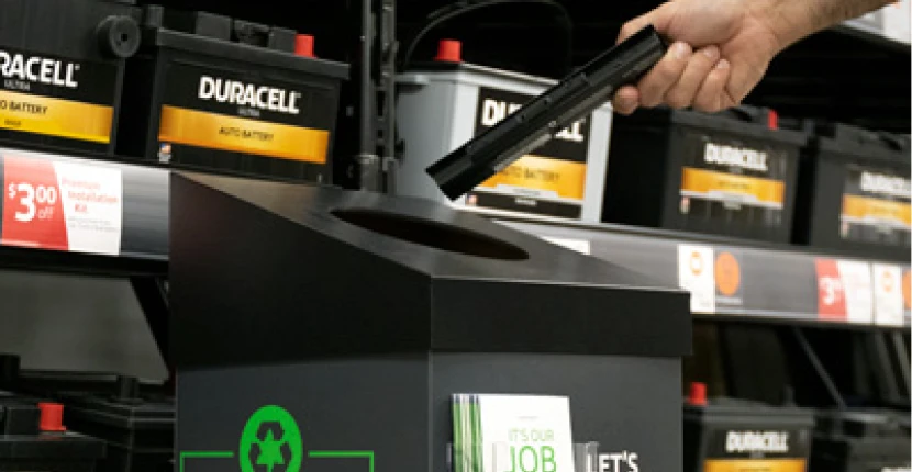 Putting a spent battery into a recycling container