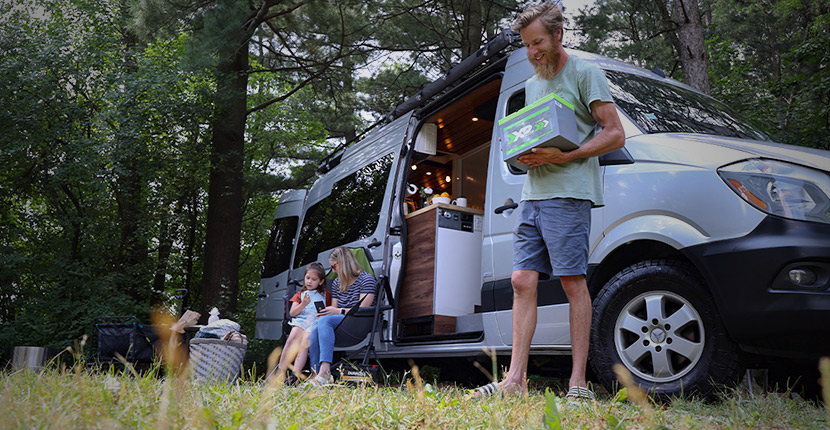 A family outside an RV