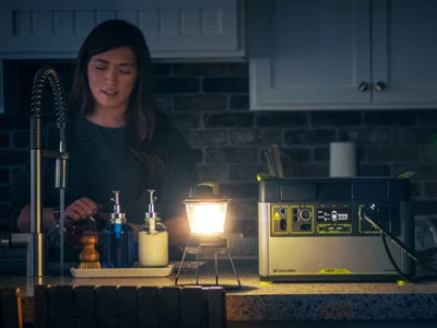 Mother and son in a kitchen with a lantern using a Goal Zero generator to power some appliances
