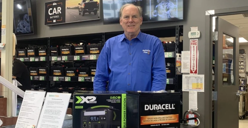 Franchisee Chris Shea standing behind the counter