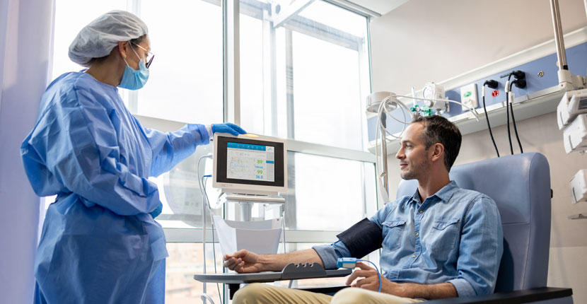 Nurse using a medical cart to check a patient