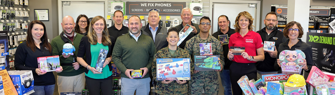 2023 Toys for Tots donation at a Batteries Plus store with the Marine Corps