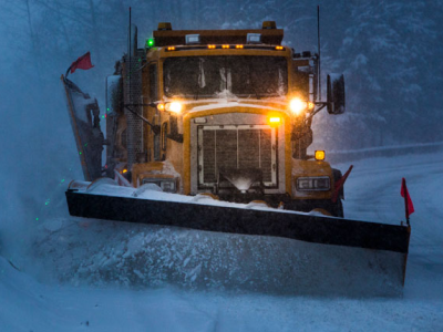 Snow plow truck plowing snow from the street