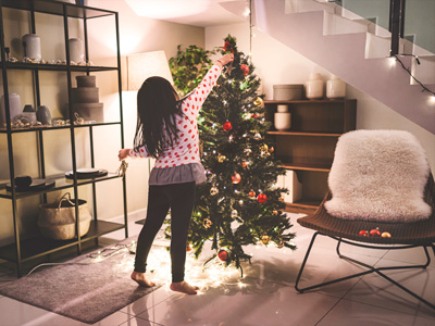 Little girl decorating a Christmas tree